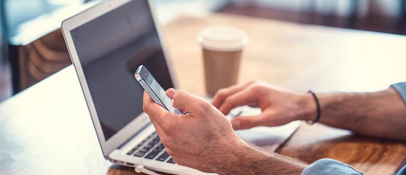 Man with laptop and phone