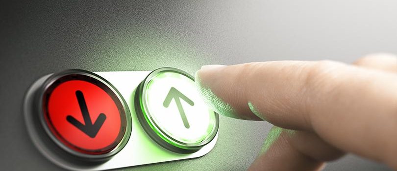 Man pressing a green button with an arrow on a simple board. Composite image between a hand photography and a 3D background.